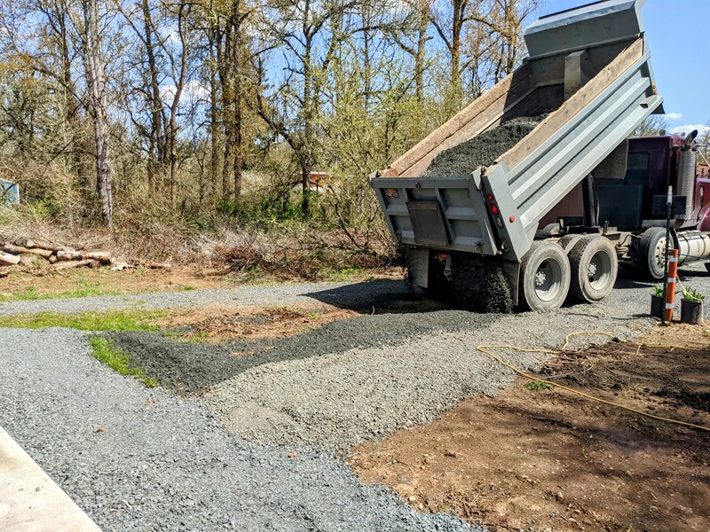 Dump truck spreading gravel.