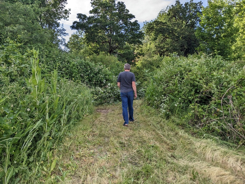 Joseph walking the path he mowed.