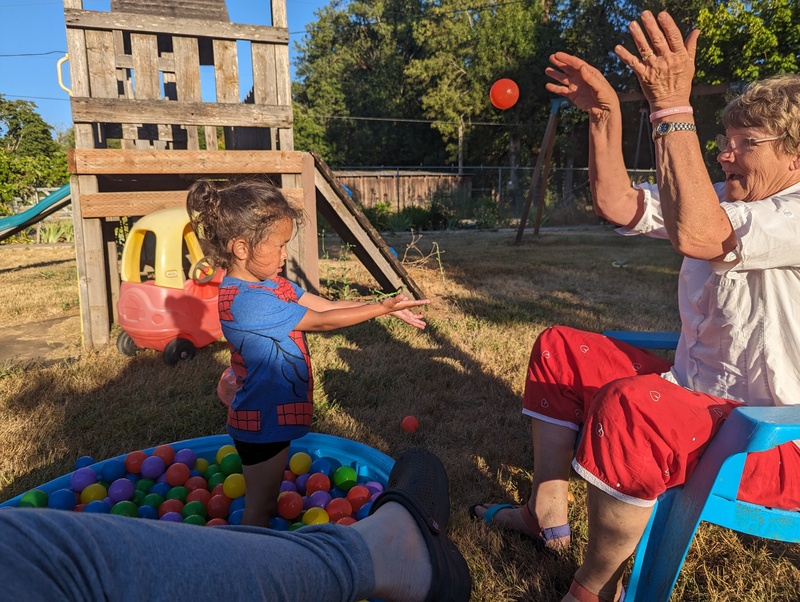 Laura playing toss with pit balls.