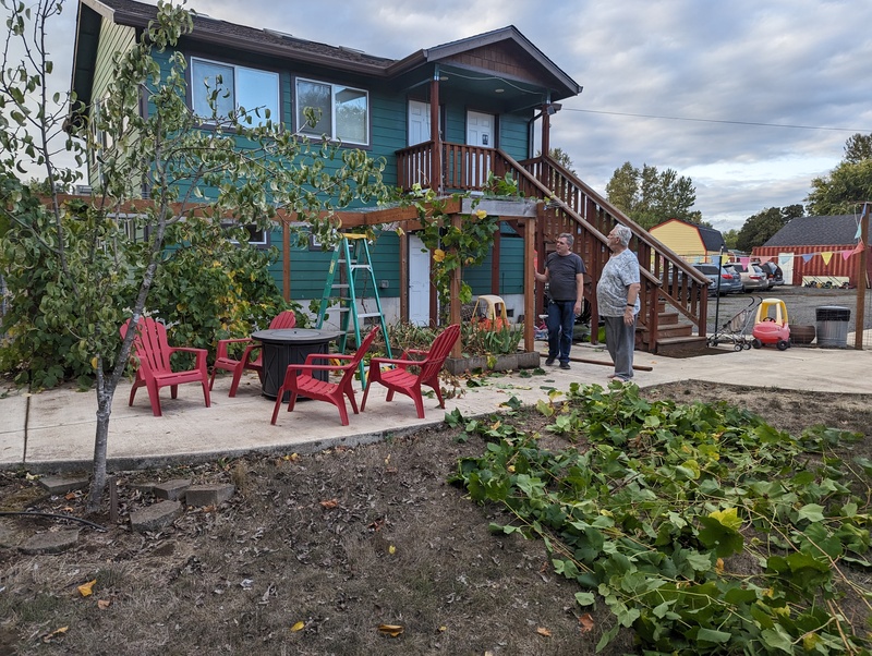 Joseph and Don inspect the grape arbor improvements.