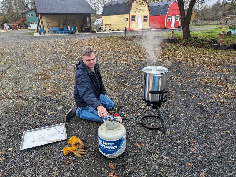 Joseph turned off and on the gas while putting the turkey in the pot.