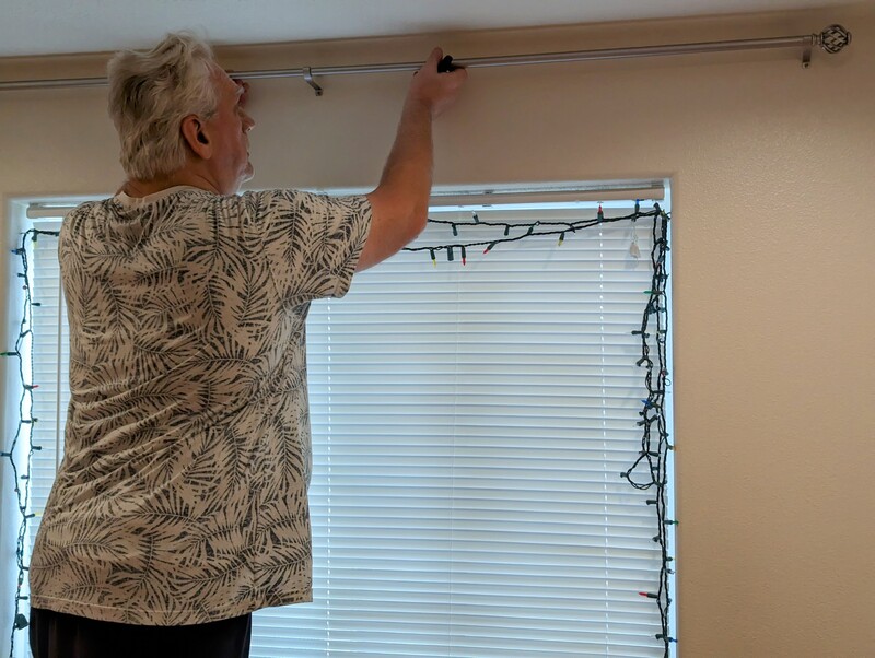 Don installs curtain rods in rm1.
