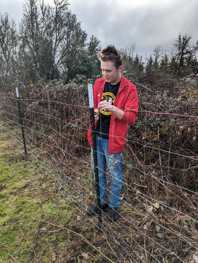 Caleb working on the fence.