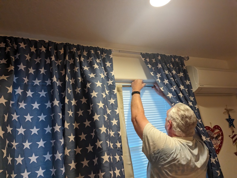 Don putting up blackout curtains in room #2
