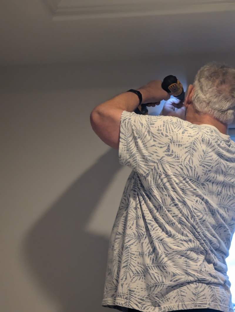 Don drilling and hanging hardware for drapes.