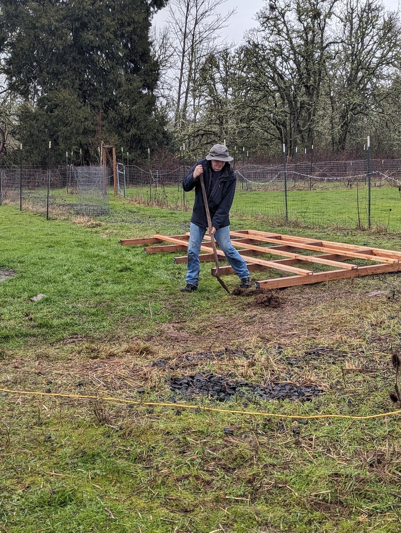 Joseph digging holes for the posts. Ah, he found the electricity and water lines.