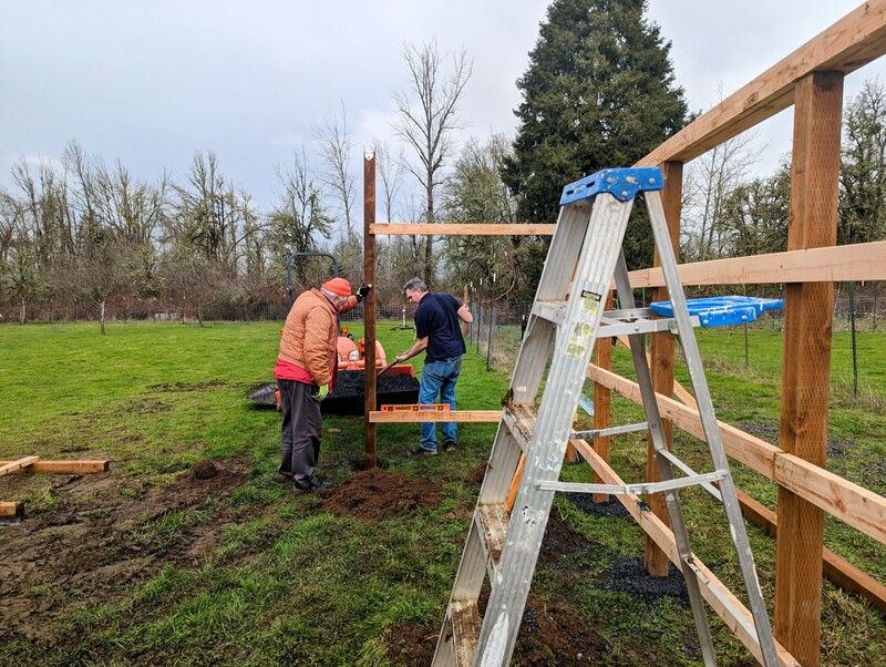 Joseph filling all the holes around the posts. Dennis.