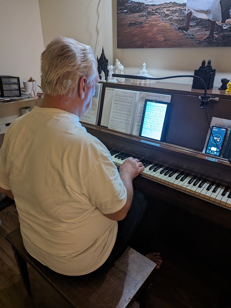 Don is using his new, experimental, 10-inch tablet to hold sheet music for the piano.