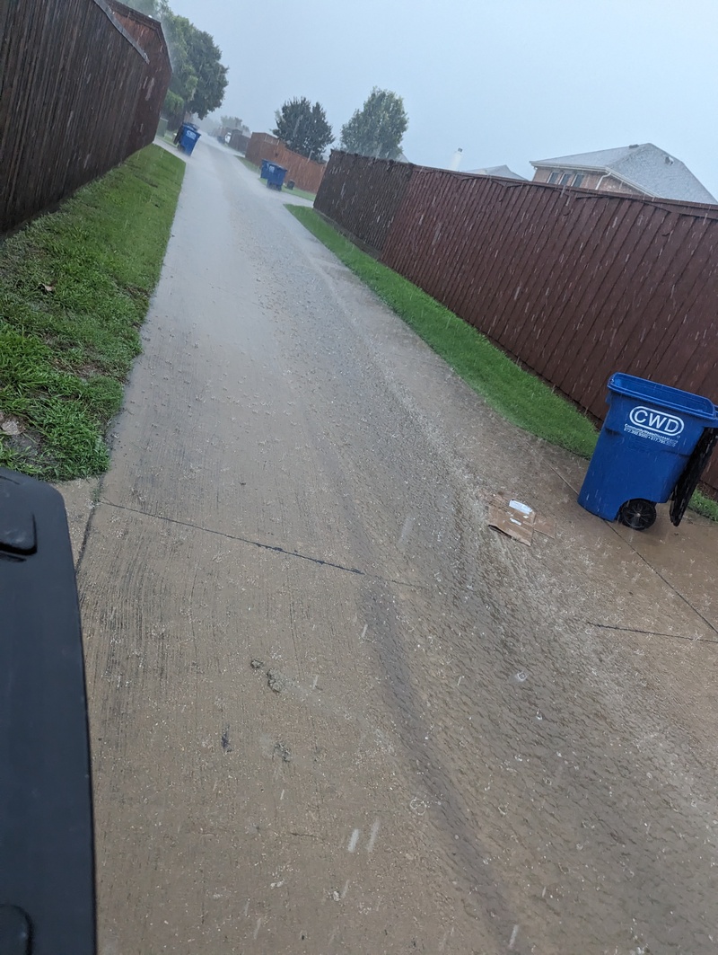 The rain runs down our back alley in Texas.