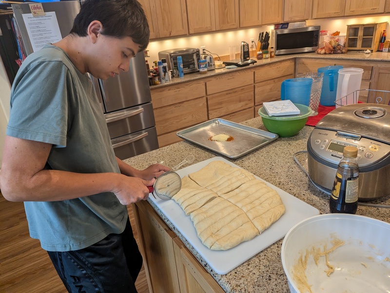 Alex making Italian breadsticks.