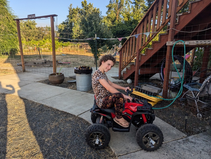 Trying to ride the 4 Wheeler.