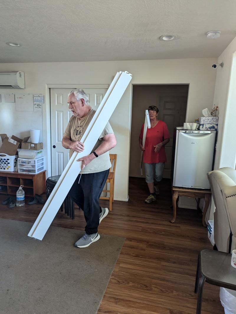 Don and Laura hauling a bed frame out to the pod.