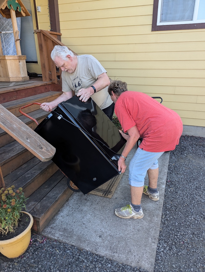 Don and Laura hauling an office fridge out to the pod.