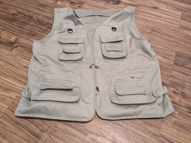 Don's "Travel Vest" aka Fisherman's Vest. Holds cell phone, wallet, power bank, keys, glasses, meds, and rubbish all without opening my carry-on or undoing my seat belt to get into my pockets.