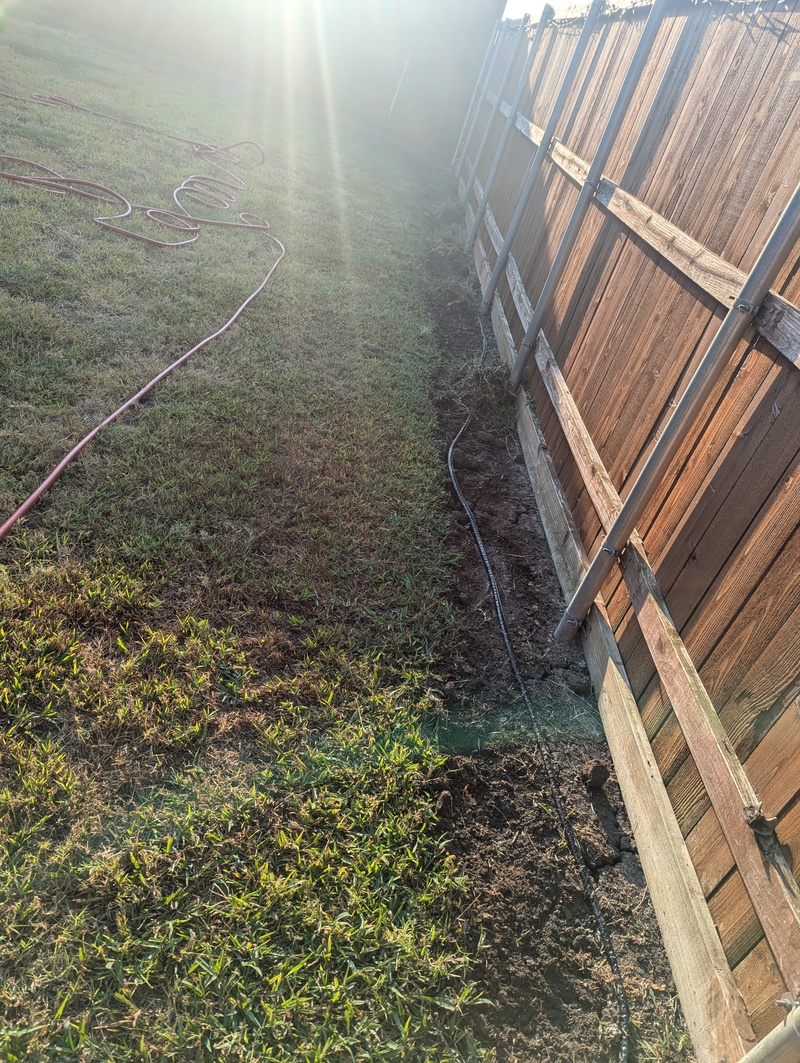 Future Garden along fence. Soaker hose.