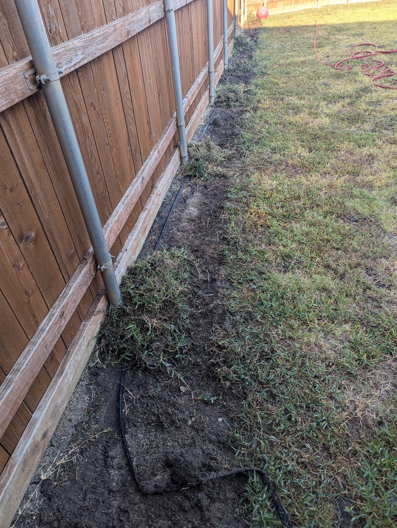 Future Garden along fence. Soaker hose.