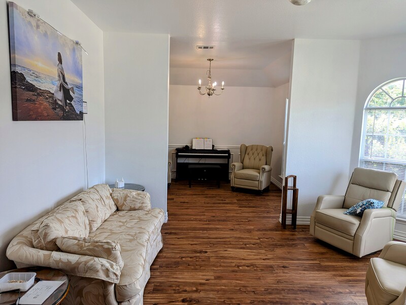 Living Room with couch and swivel rocker recliners. Piano room with recliner.