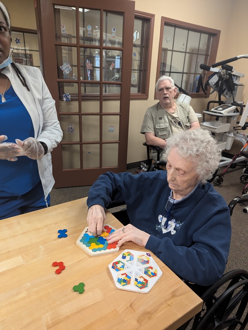 EJean demonstrates her mental acuity while Don looks on.