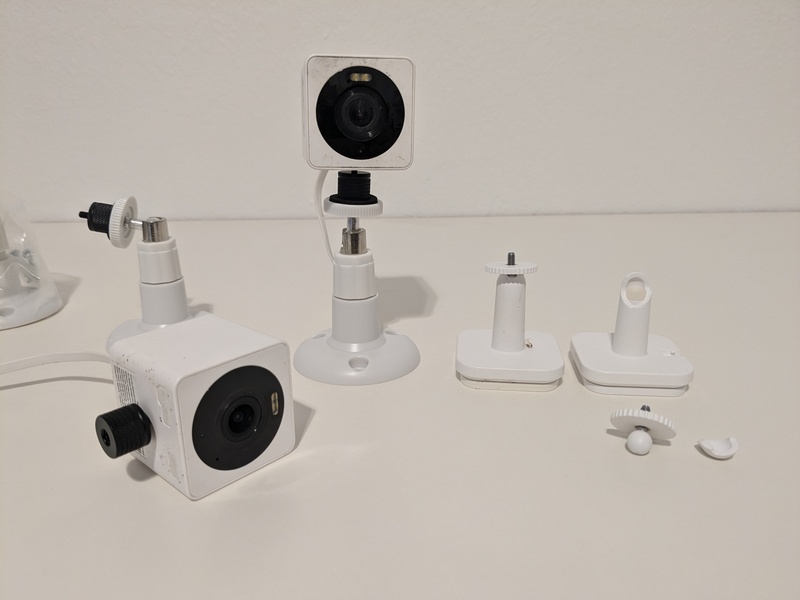 Wyze surveillance cameras on their new mounts, plus a broken old mount that forced me to look on Amazon for alternatives.