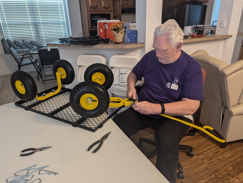 Don assists Lois in putting together her new Garden Cart.