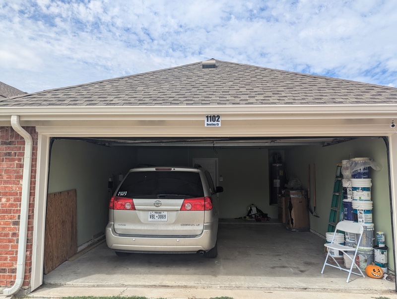 House numbers from the driveway. Pretty empty garage except all the paint cans that were left