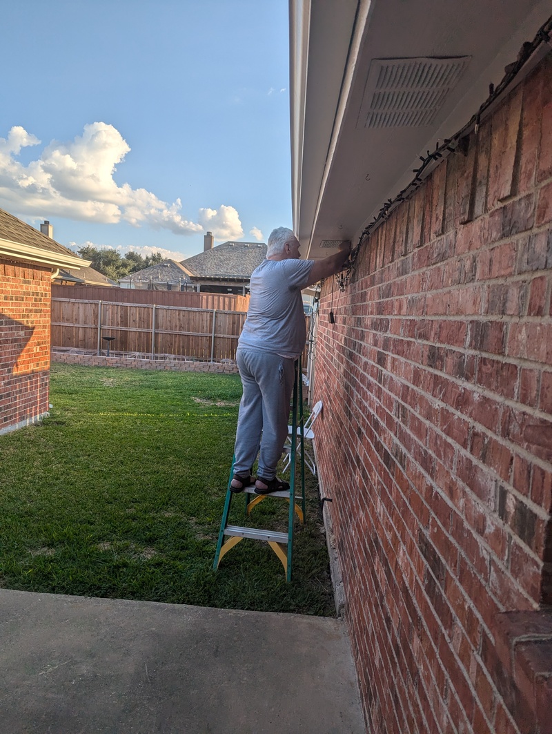 Don installs his cord management solution: coat hooks under the eaves.  It worked great for hanging the PurpleAir sensor.