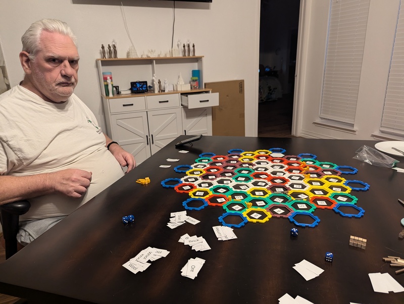 Catan 61 tile setup. Why is Don looking so grumpy? Is Lois winning the game? No, he is just contemplating how to make things better. Don won this first round. 🤣