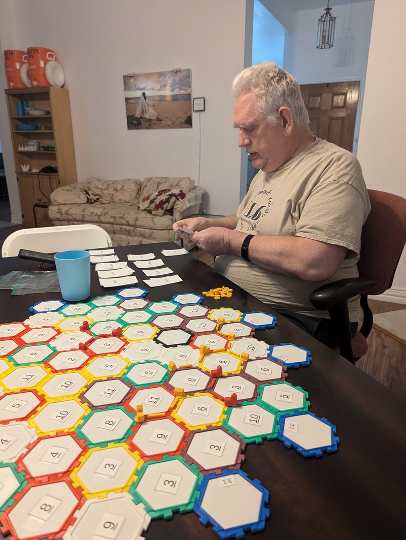 Another game of Catan. Paper numbers version one taped to hex tiles.