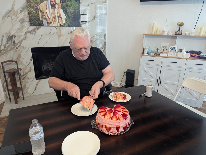 Don cuts the Strawberry-topped cake made by Cindy.