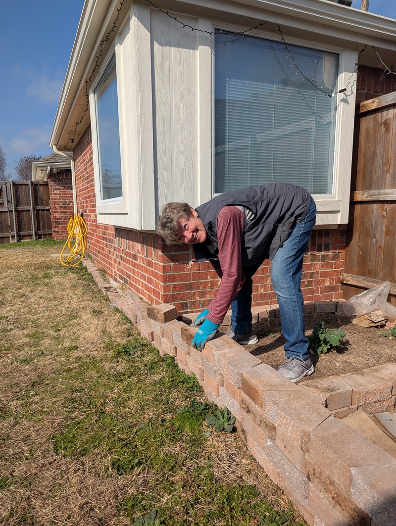 Laura Neilson works with Lois to expand the vegetable garden area.