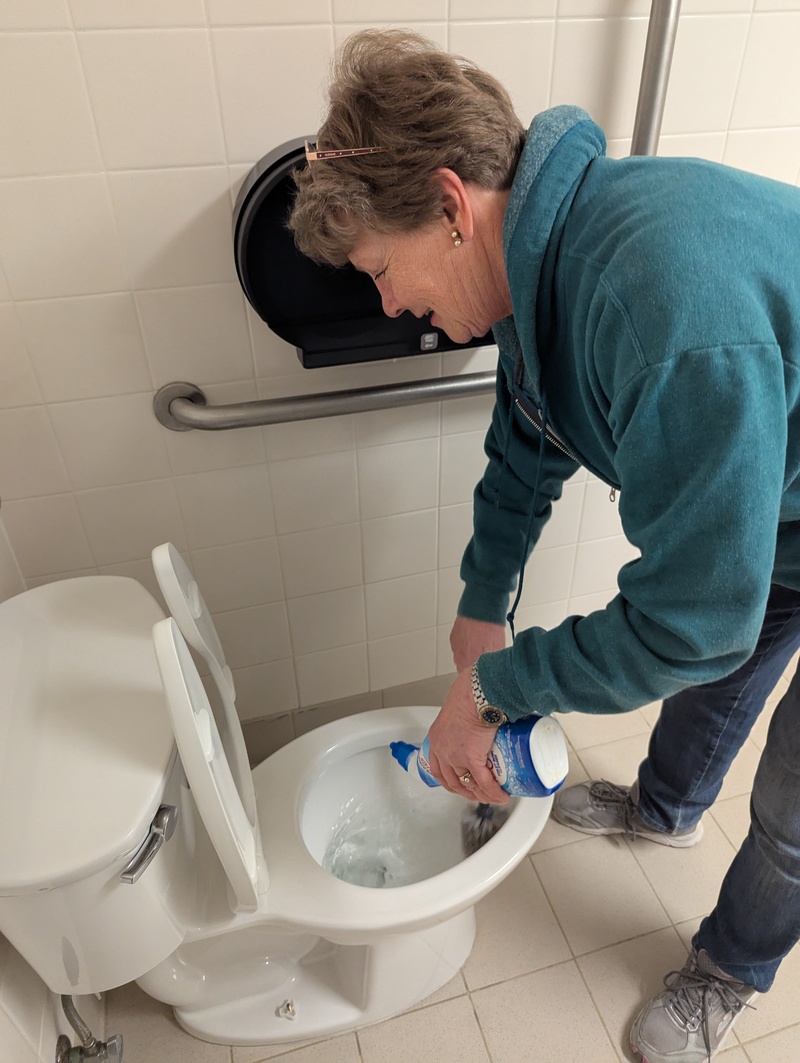 Laura Neilson having too much fun cleaning a toilet at our church building.