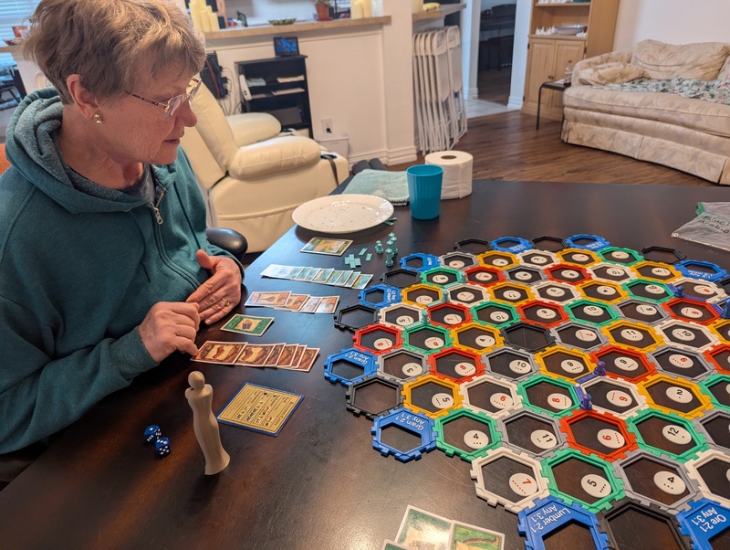 Laura is learning how to play Settlers of Catan.