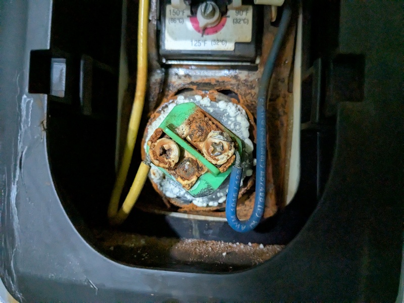 The upper water heater heating element is corroded on the outside.