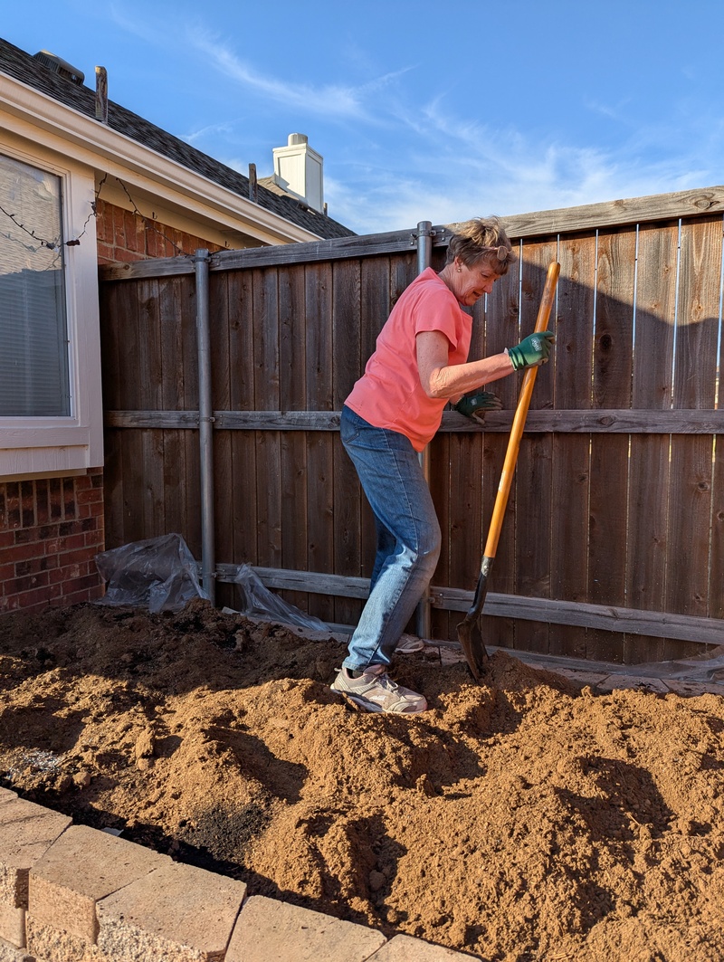 Laura turning over dirt.