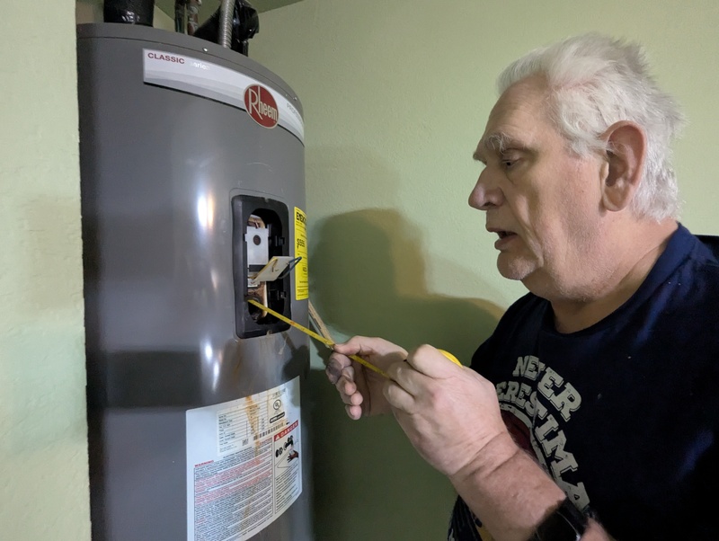 Don working on the water heater.