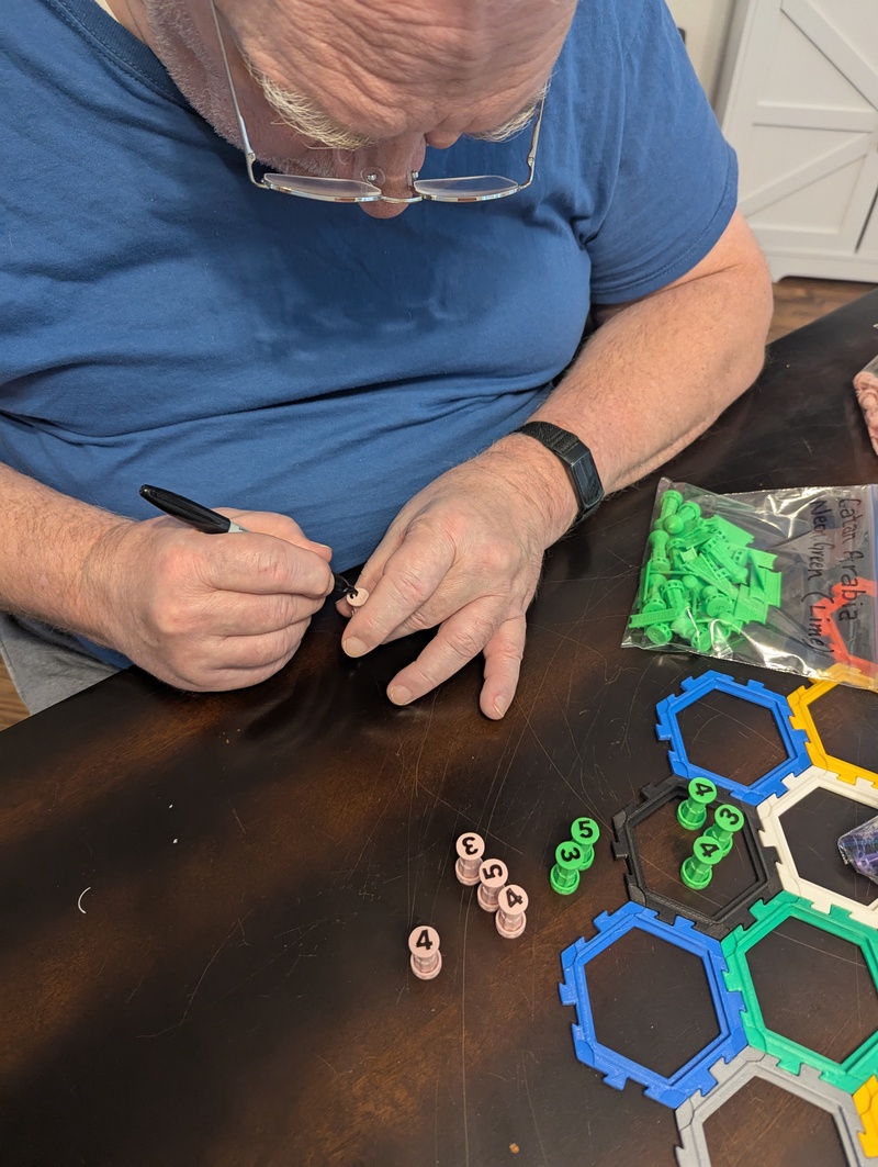 Don marks the 3 4 5 Super Cities pieces with Sharpie to make the numbers more visible.