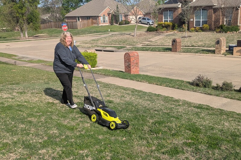 Lois uses her new lawn mower.