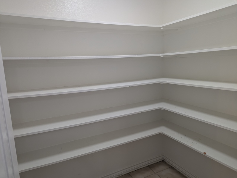 The pantry is empty, ready for renovation.