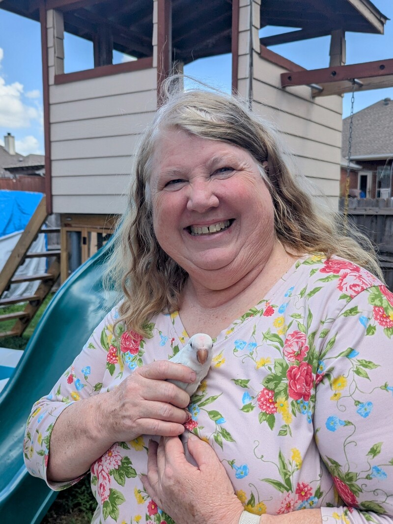 Lois holds one of Javier's birds.