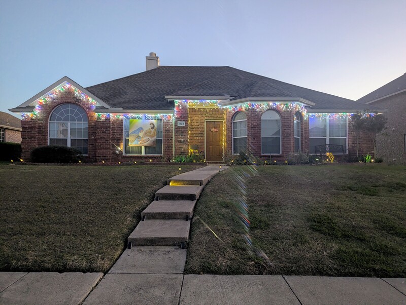 The outdoor lights are up and on. The painting is up. A friend helped us out in the last hook so we could do the peak.