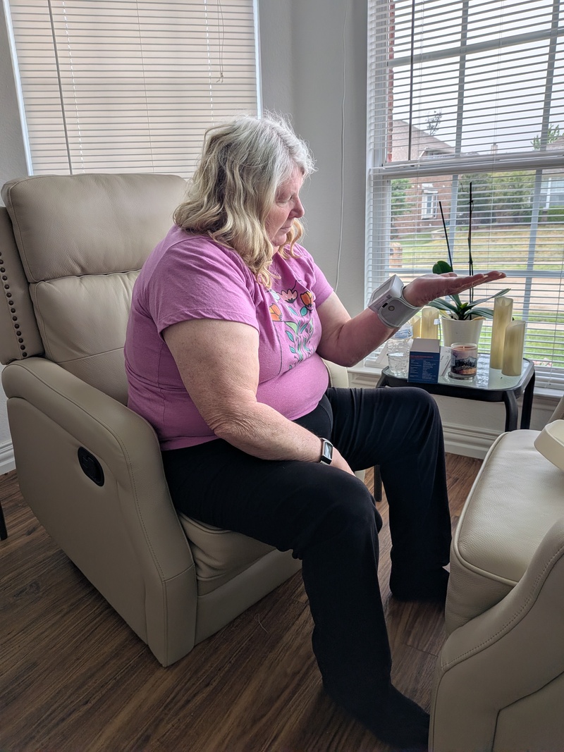 Lois checking her blood pressure.