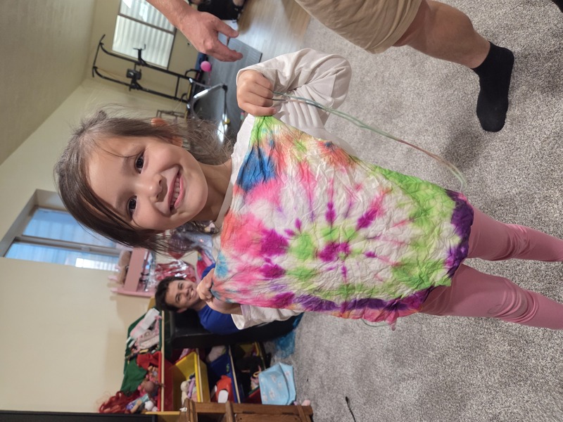 Fei Fei shows of the shirt she made at the library